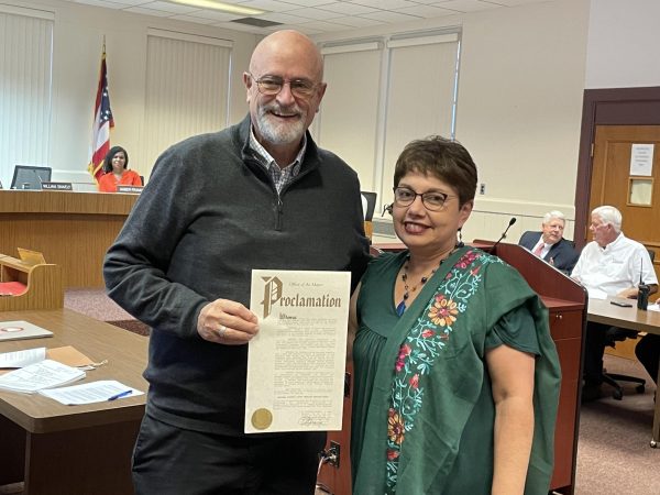 Mayor William Snavely offers Jacqueline Rioja Velarde an official proclamation of National Hispanic Latin American Heritage Month at the city council meeting Sept. 19.