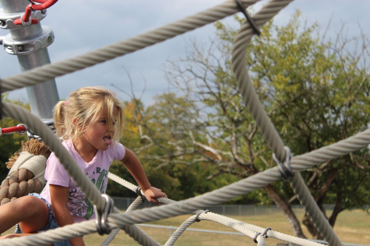 Lilah+Rodbro%2C+5%2C+climbs+on+the+new+playground+equipment+at+Kramer+Elementary+School.