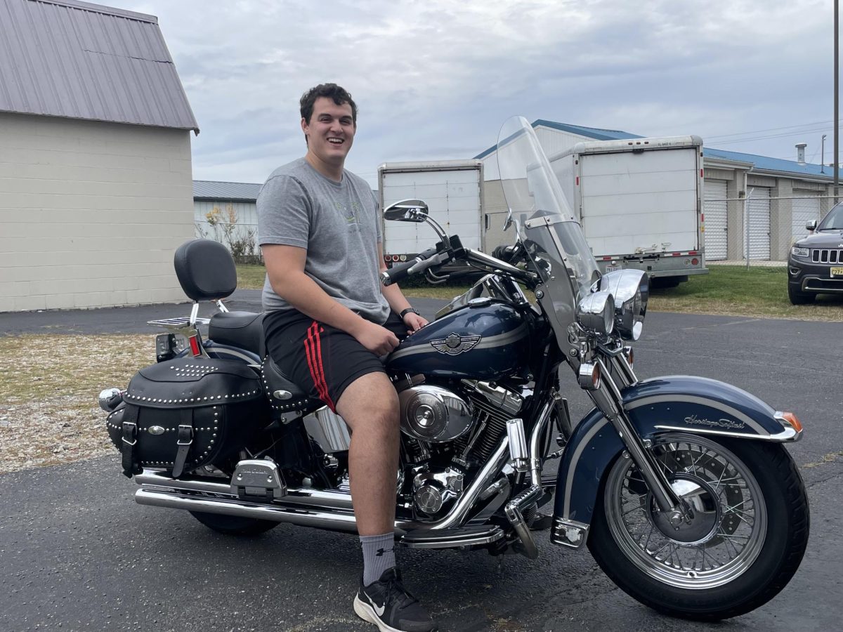 Dean Silverberg, a Miami junior from New Jersey, astride his Harley Davidson.
