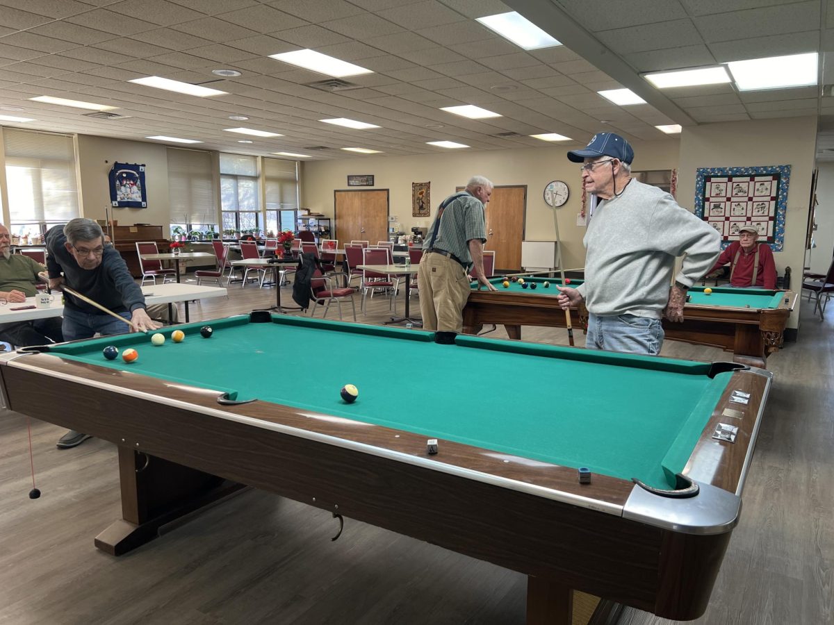 Two members of Oxford Seniors play pool at the current senior center on Feb. 13. Photo by Sean Scott.