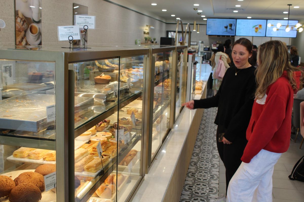 Faith Tanis and Riley Costello peruse the racks of baked goods at Tous les Jours in Oxford just before noon on Feb. 14.