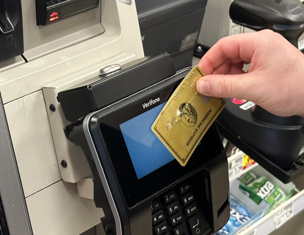 A student swipes his card at Kroger. 