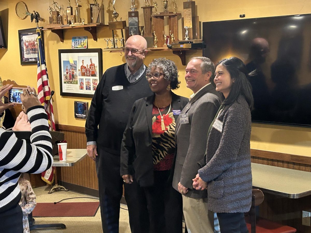 (Left to right) Bill Snavely takes a picture with Ohio legislature candidates Vanessa Cummings, Tom Cooke and Chantel Raghu.