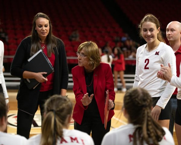 Coach Carolyn Condit speaks to her team during a break in the match.
