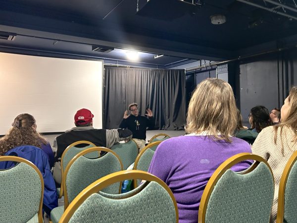 Filmmaker Travis Zariwny talks to the audience following a showing of his film “Cabin Fever” in the Oxford Community Arts Center last weekend. Photo by Ryann Beaschler
