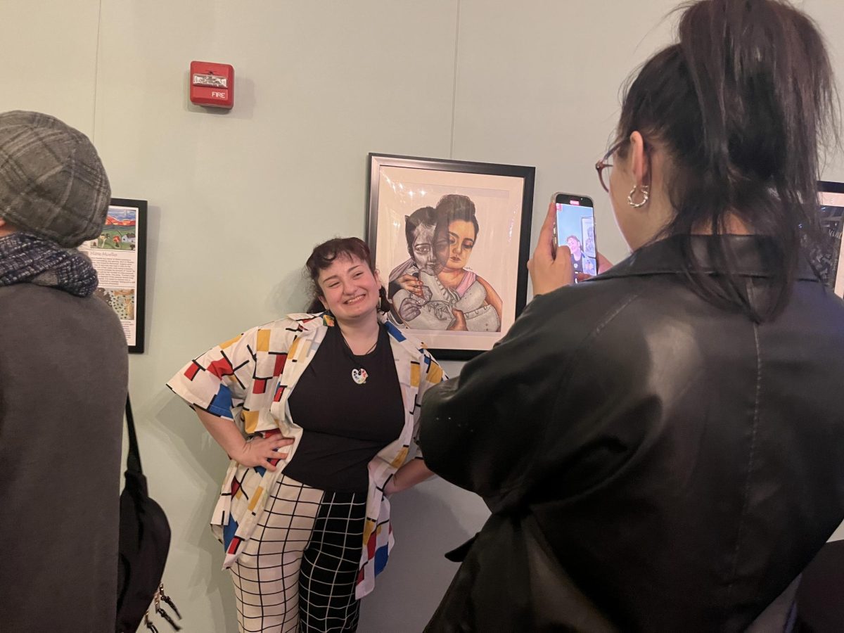 Isa Obradovich stands by her artwork, “Reminiscence” which was displayed at the Oxford Community Center undergraduate student response exhibition.