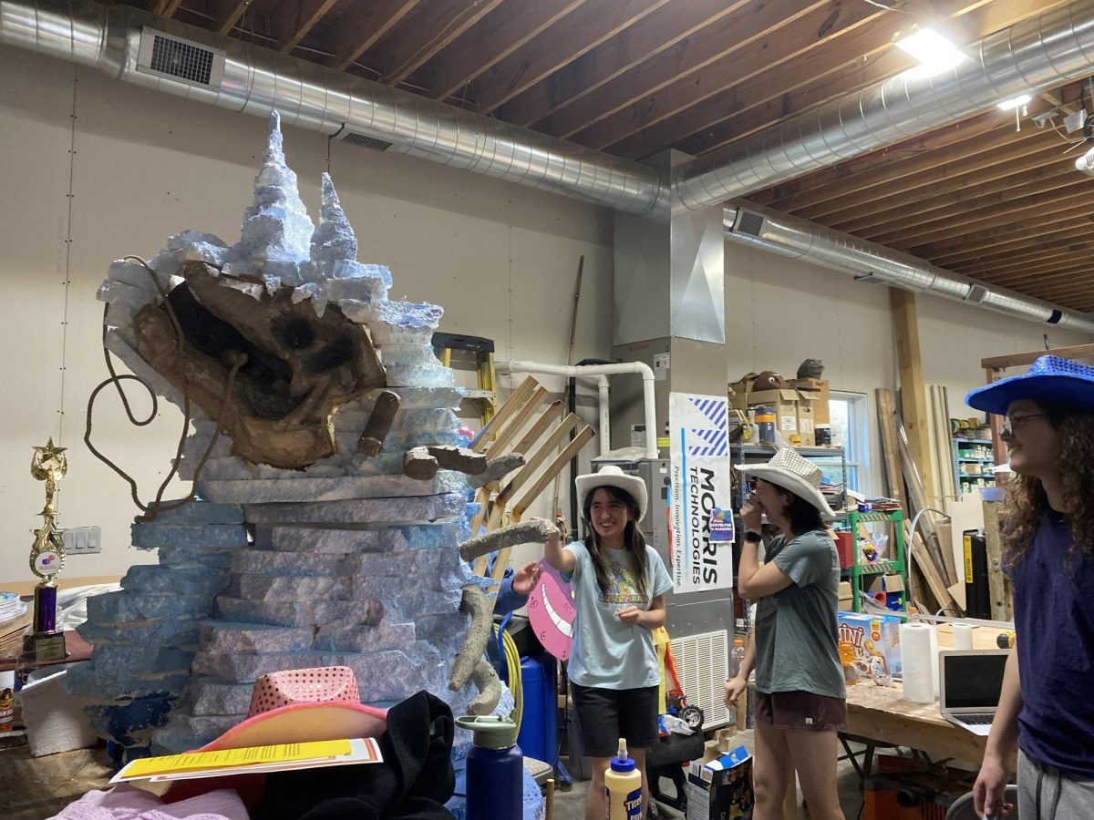 The team built a dinosaur sculpture for their scientific challenge puppet. The dinosaur engineers on a crank attached to their wooden backdrop to be controlled during the skit. 