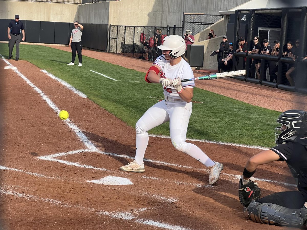 Hadley Parisien takes a swing at the plate for Miami.