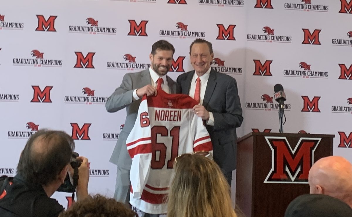 Miami%E2%80%99s+new+head+hockey+coach+Anthony+Noreen+poses+with+athletic+director+David+Sayler+on+Tuesday+at+Noreen%E2%80%99s+introductory+press+conference+at+Goggin+Ice+Center.