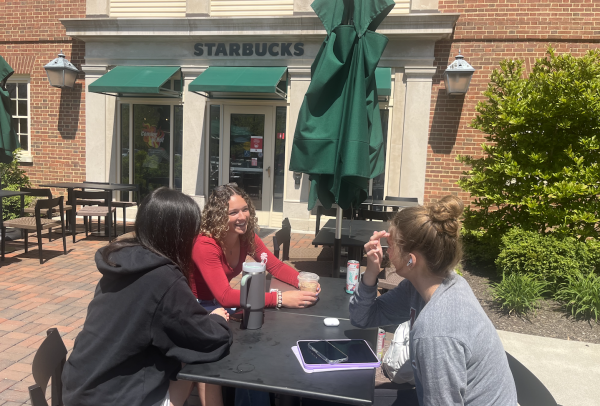 Miami University students Rhian Clane, Shannah Whitlock and Ava Sabin converse over a coffee outside the Shriver Starbucks.