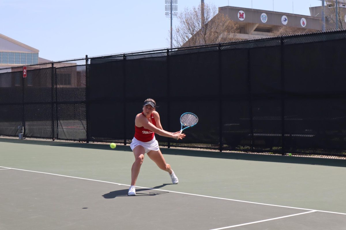 Junior Sara Zalukar returns the ball to Buffalo opponent during crucial singles competition.