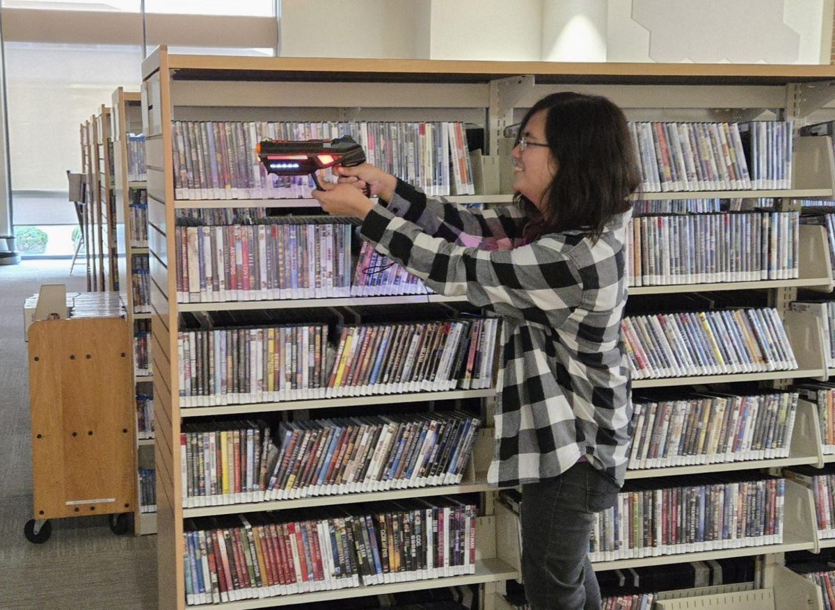 Lane Library staff member Fabio Chirinos participates in the Teen Laser Tag program he helped to organize at the Oxford Lane Library after multiple requests from the teenage participants.