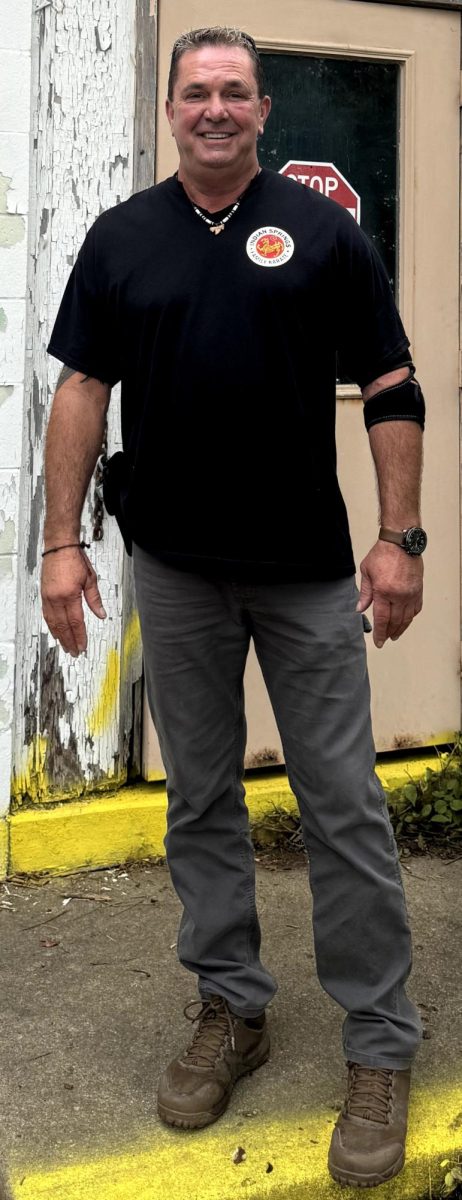 Jesse VonStein, owner of the Area 13 Project, stands in front of the entrance to one of the nine buildings on the property.
