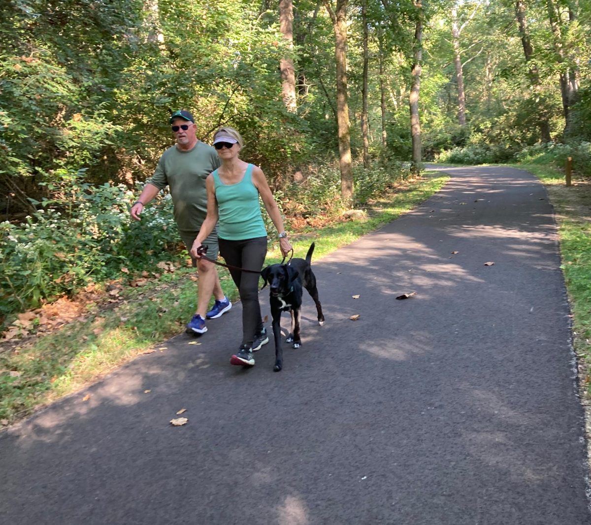 John and Ann Schmitt spend their morning walking their two-year-old Labrador Retriever mix Buddy.