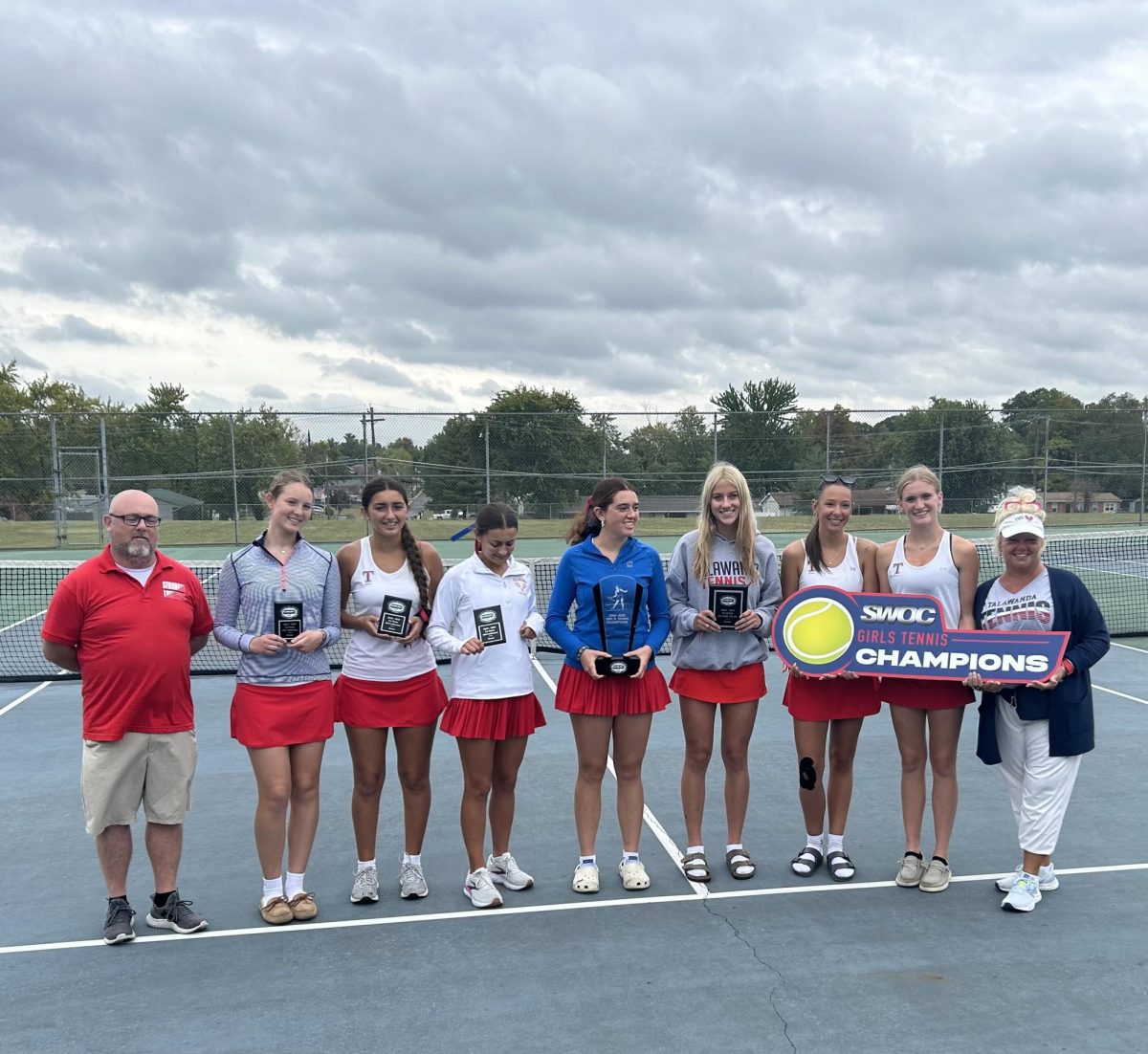 Talawanda Varsity Girls hold their trophies and championship sign with JV and Varsity coach on opposite ends. Provided by Nate Silberstein.