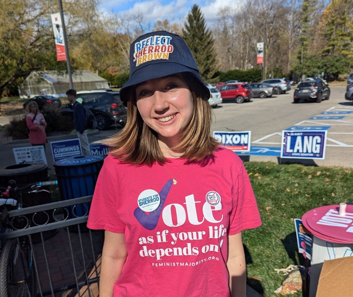 Keara Kelleher encourages others to vote blue outside of Marcum Hall. 