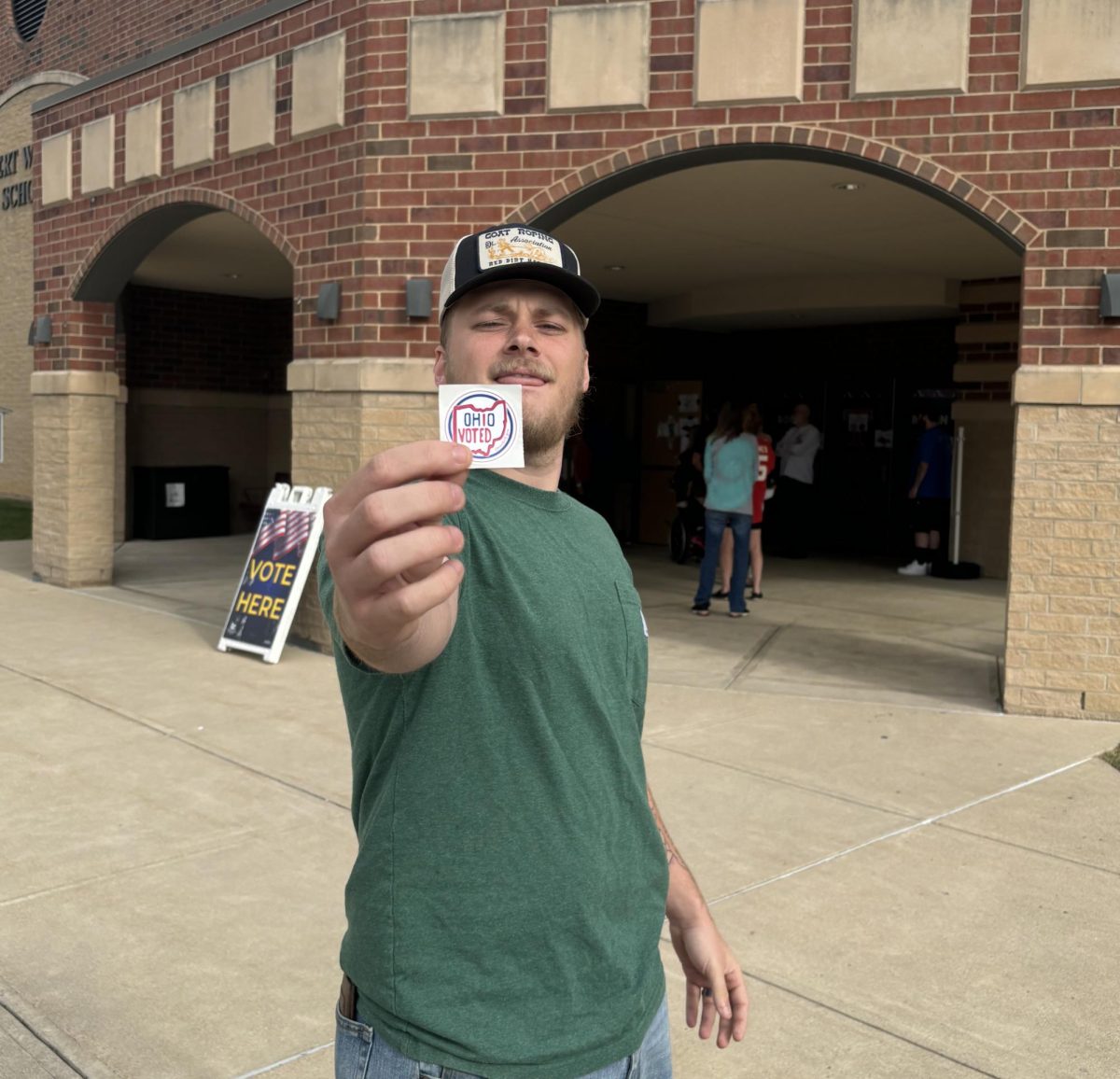 Tanner Campbell proudly flashes his voting sticker after voting in the 2024 election. 