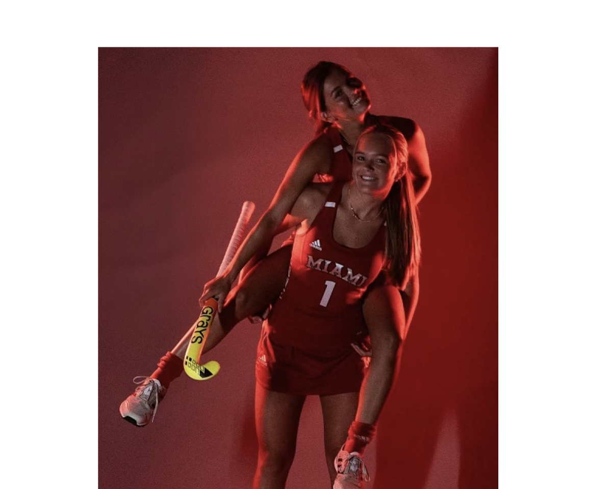 Sloane Wearren carries her sister Reese on her back during a Miami field hockey press event.