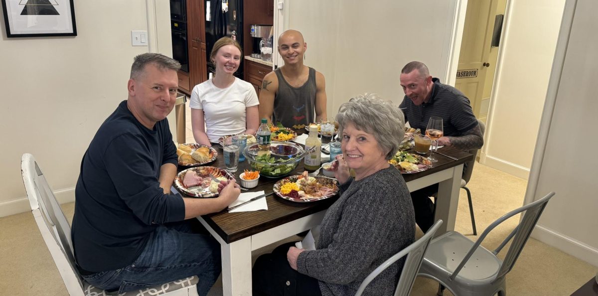 Derek Womble (left), Emma Rutledge, Azul Cook, Barb Womble and Eich Buscher sit down to Thanksgiving dinner. Photo provided by Margaret Cook