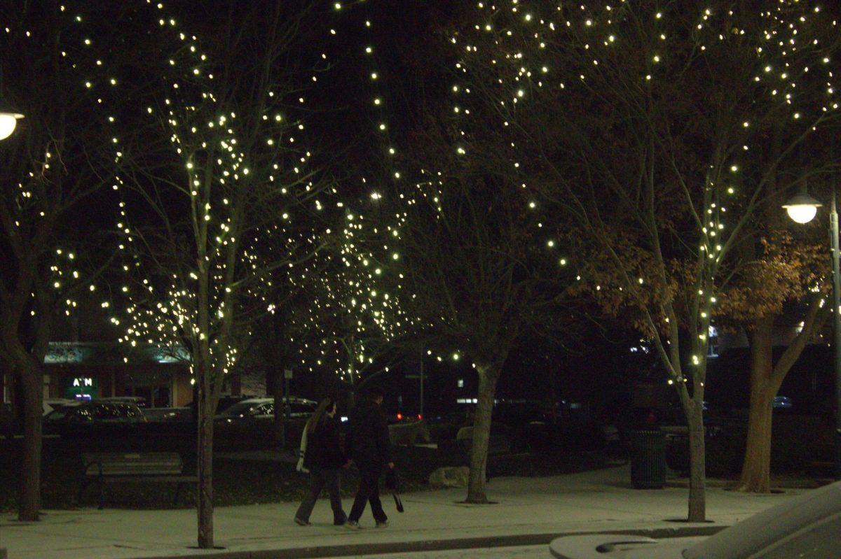 A couple holds hands while walking by Uptown Park. Photo by Gina Roth
