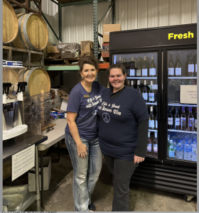 Vickie Ralph and Sarah Singleton work the front-of-house register and bar while giving out samples at Hanover Winery. 