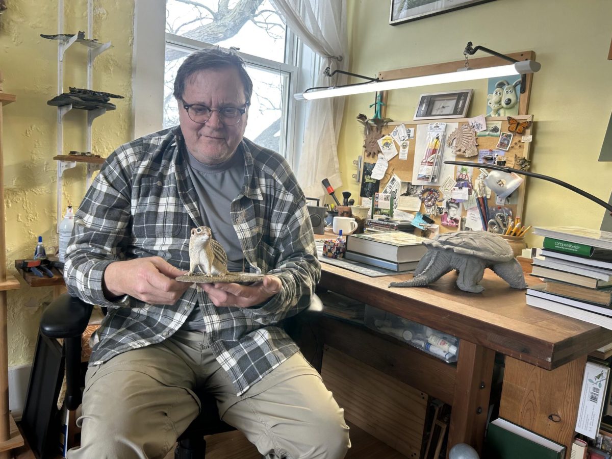 Michael Wright shows off one of his handmade clay models, a chipmunk, in his studio at the Oxford Community Arts Center.