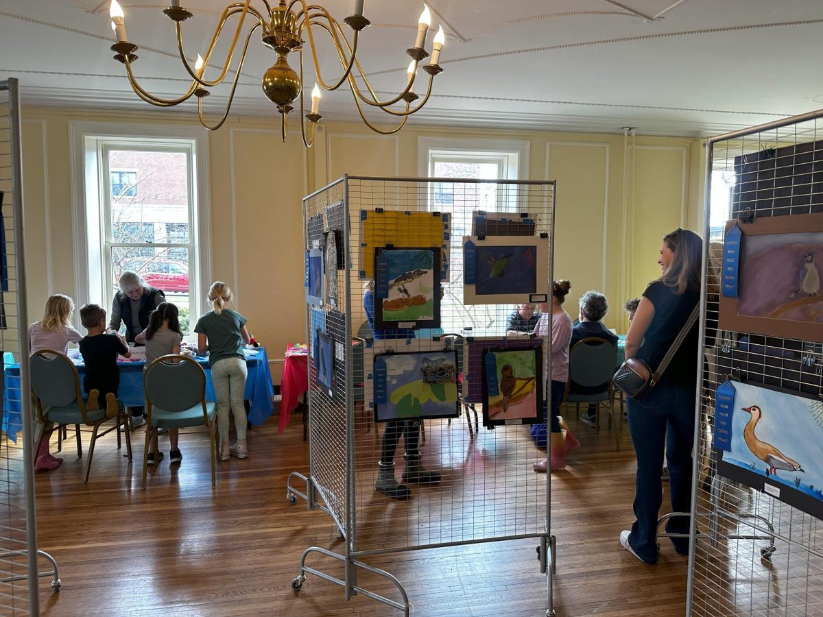 Students and their families engage in the materials Audubon Miami provided during the 11th Annual bird art exhibition in OCAC